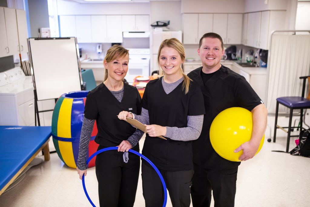 Occupational Therapy Assistant students working with exercise equipment
