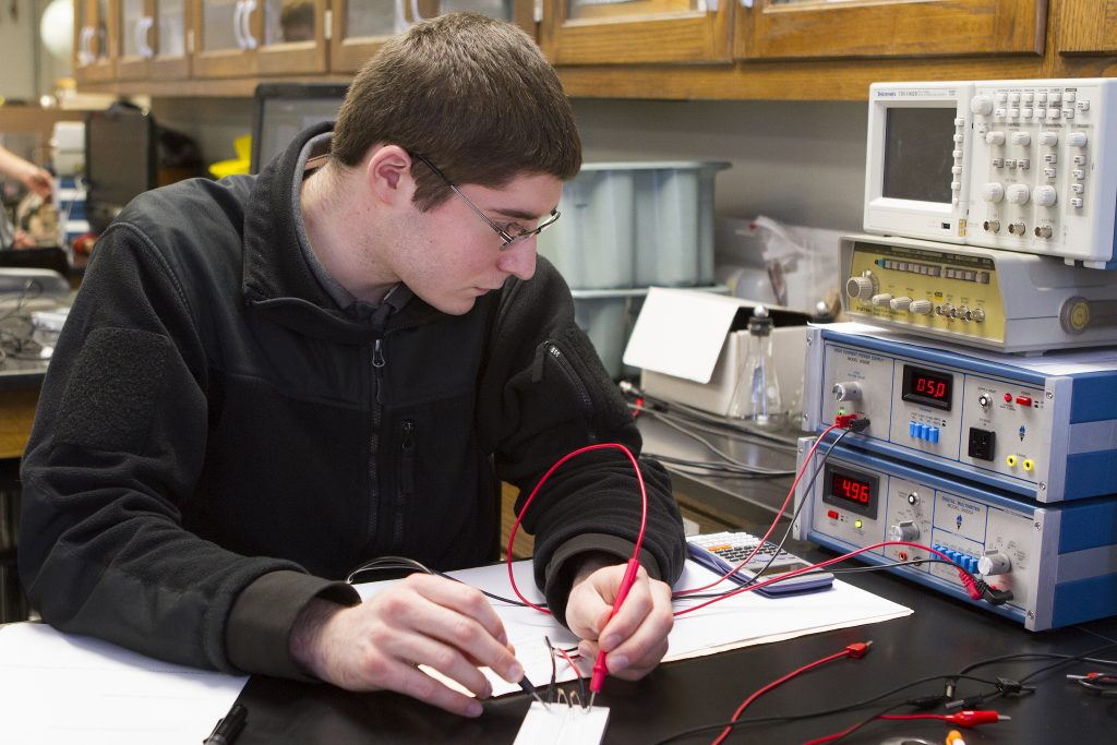 An engineering student working on a wiring project