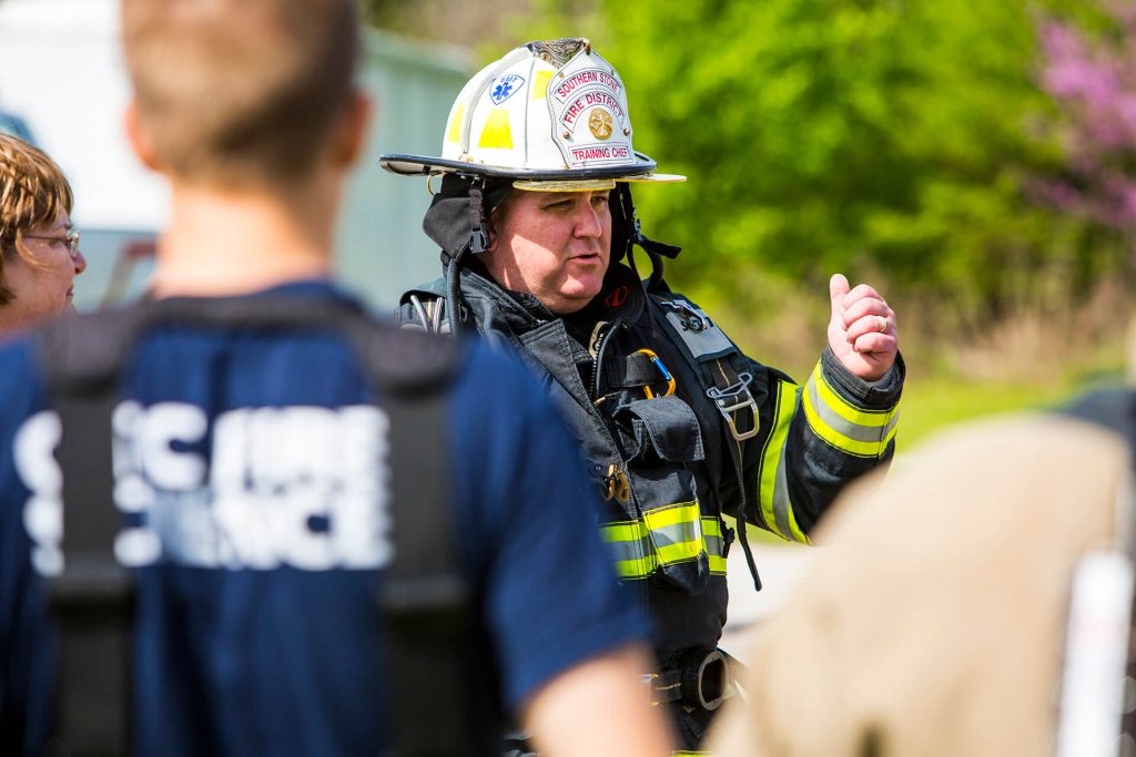 A fire science instructor training his students