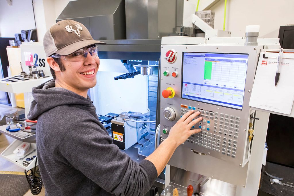 A precision machining student working on a machining interface
